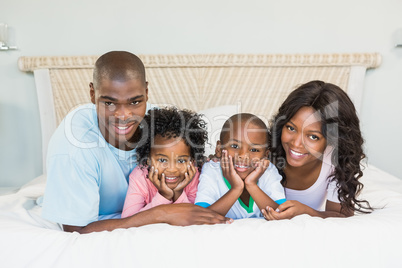 Happy family lying on bed