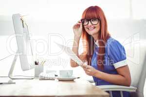 Smiling hipster woman with document