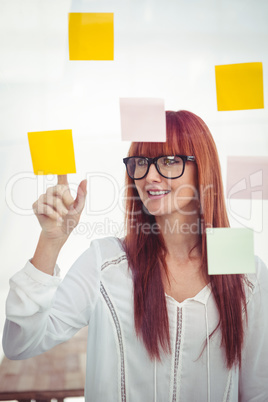 Attractive hipster woman pointing sticky notes