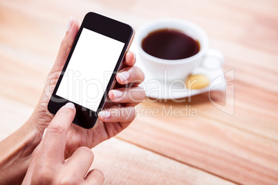 Overhead of feminine hands using smartphone