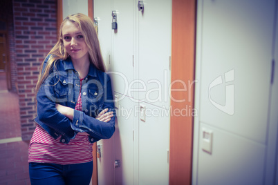 Smiling student leaning against the locker