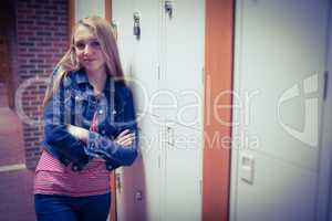 Smiling student leaning against the locker