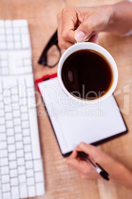 Businesswoman holding black coffee cup