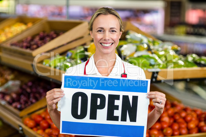 Smiling woman holding sign