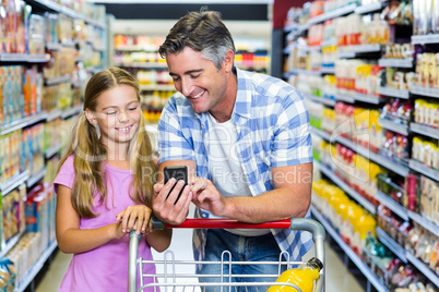 Smiling father and daughter at the supermarket