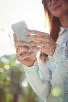 Smiling woman using smartphone