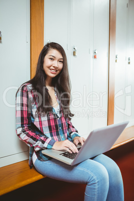 Smiling student sitting at the computer