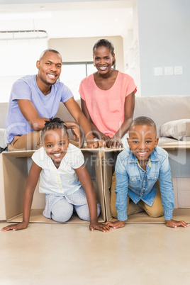 Casual happy family posing with box