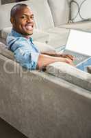 Over shoulder view of casual man using laptop