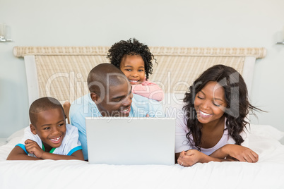 Family having fun together in bed