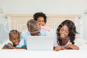 Family having fun together in bed