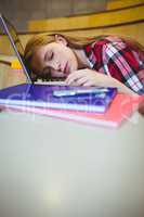 Blonde student sleeping on laptop