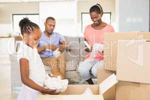 Family unwrapping things in new home