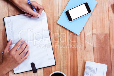 Overhead of feminine hands writing