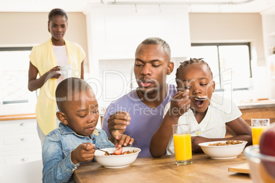 Casual happy family having breakfast