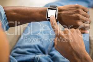 Close up view of a casual man using smart watch