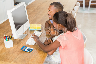 Smiling casual family on a computer