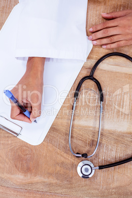 Doctor writing on clipboard Doctor writing on clipboard