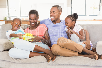 Happy young family giving a present to their son