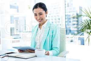 Businesswoman using her tablet pc