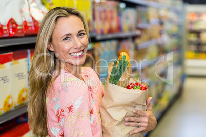 Beautiful woman standing with grocery bag