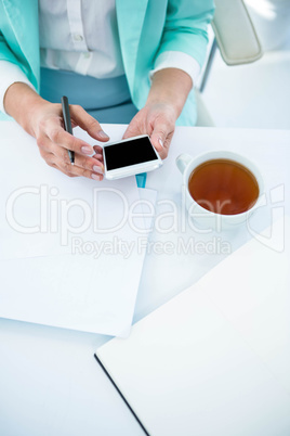 Businesswoman using her smart phone