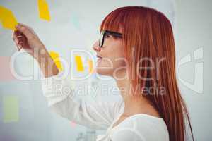 Attractive hipster woman holding  sticky notes