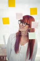 Attractive hipster woman looking at sticky notes