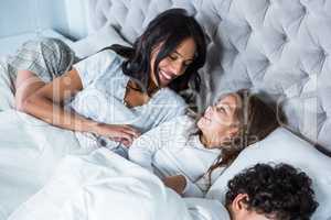 Happy family in bed waking up