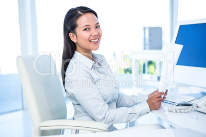 Smiling businesswoman holding document