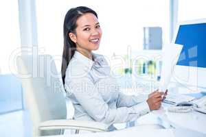 Smiling businesswoman holding document