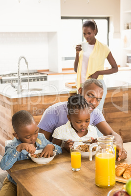 Casual happy family having breakfast