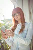 Smiling woman using smartphone