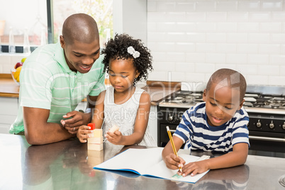 Father with children in the kitchen