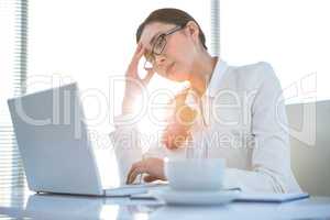 Stressed businesswoman at laptop