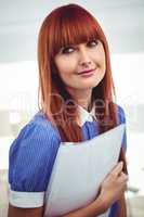 Smiling hipster woman holding document