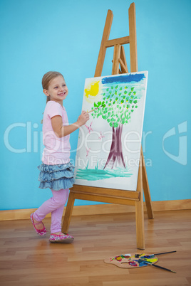 Smiling girl beside her picture