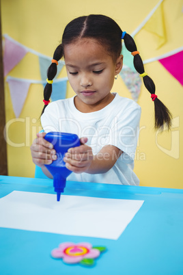 Girl holding a bottle of glue