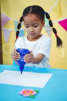 Girl holding a bottle of glue