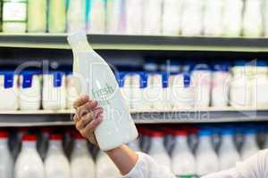 Woman hand holding milk bottle