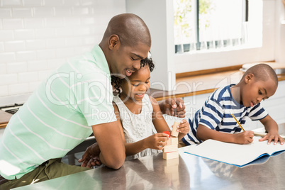 Father with children in the kitchen