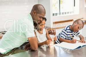 Father with children in the kitchen