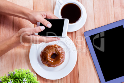 Overhead of feminine hands using smartphone