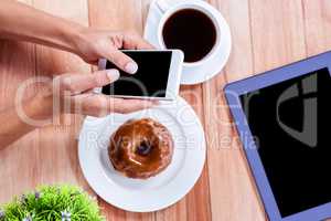 Overhead of feminine hands using smartphone