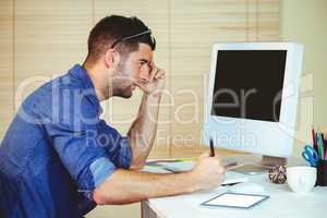 Handsome hipster working at desk