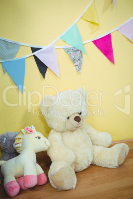 Decorations and fluffy teddies against the wall