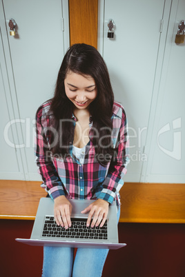 Smiling student sitting at the computer