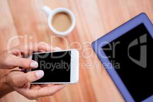 Overhead of feminine hands using smartphone