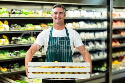 Smiling worker carrying vegetables box Smiling worker carrying vegetables box