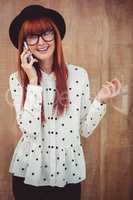 Smiling hipster woman having a phone call